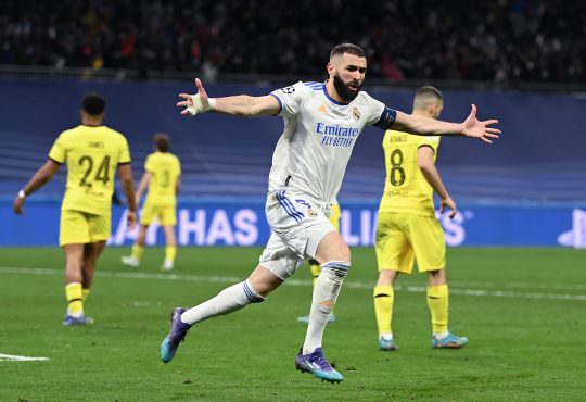 Karim Benzema von Real Madrid bejubelt einen Treffer. Im Hintergrund sind drei niedergeschlagene Chelsea Spieler.