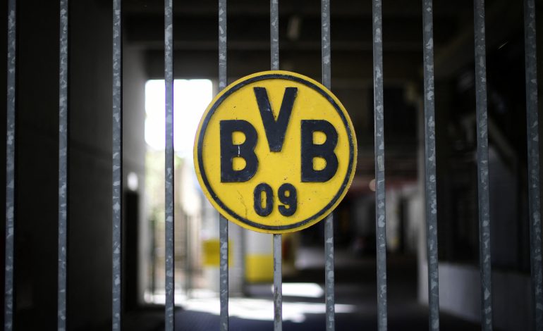 Das Logo von Borussia Dortmund auf einem Zaun. Der Text handelt von Oliver Lukic